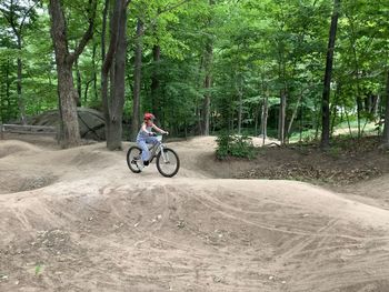 Man riding bicycle in forest