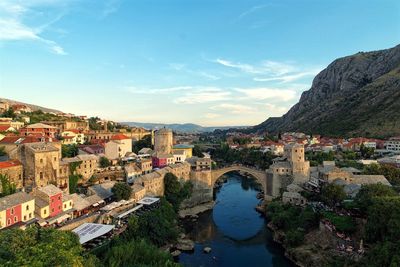 High angle shot of river with bosnian cityscape in background