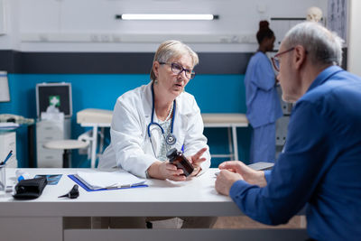 Female doctor examining patient in office