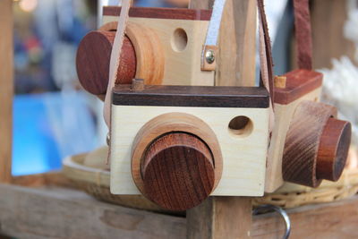 Close-up of wooden cameras hanging at store