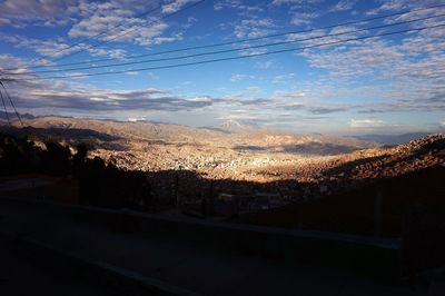 Aerial view of cityscape against dramatic sky