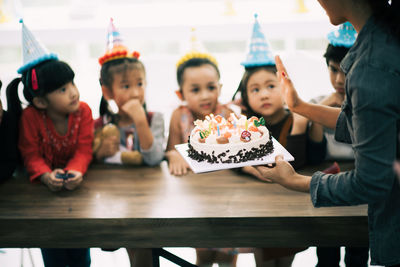 Cute happy friends enjoying birthday party at home