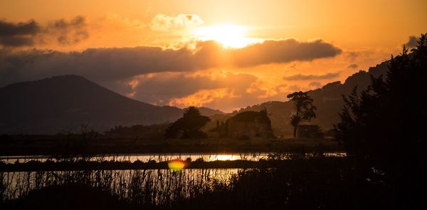 Scenic view of lake against sky during sunset