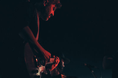 Portrait of guitarist playing in a concert