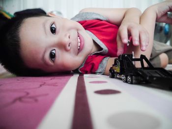 Portrait of happy boy on table at home