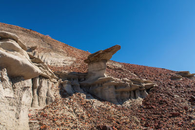 Bisti badlands landscape of strange hoodoos or rock formations on a small hill in new mexico