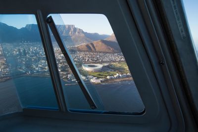 Aerial view of cityscape seen through airplane window