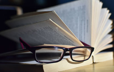 Close-up of eyeglasses on table/book