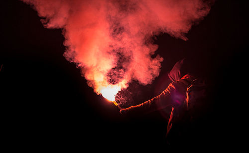 Firework display against sky at night