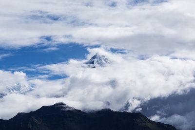 Scenic view of mountains against cloudy sky