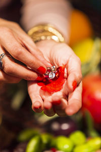 Close-up of woman holding red leaf