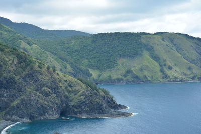 Scenic view of sea and mountains against sky