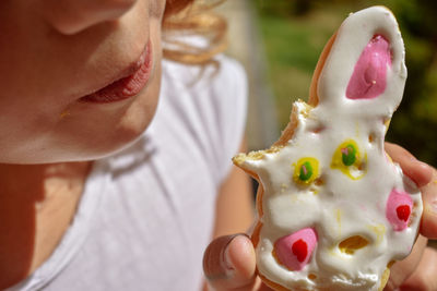 Midsection of girl having cookie outdoors