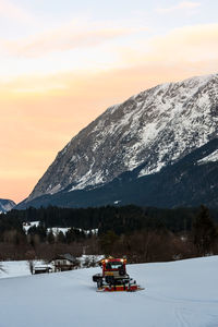 Scenic view of snowcapped mountains against sky during sunset