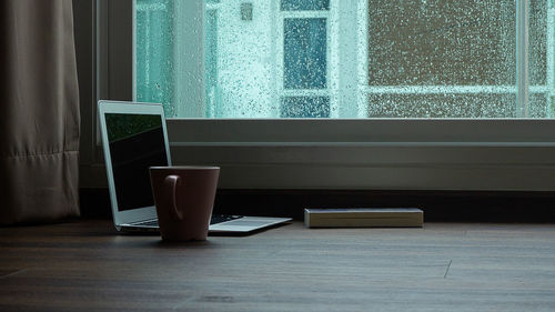 Close-up of coffee cup on table at home