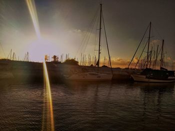 Sailboats in marina at sunset