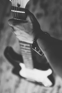 Close-up of man playing guitar
