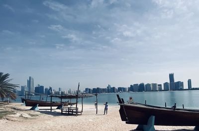 Panoramic view of sea and buildings against sky