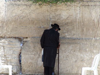 Man standing against wall