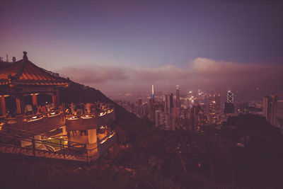 Illuminated cityscape against sky at night