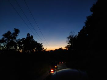 Silhouette trees against sky at sunset