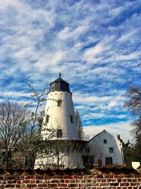 Low angle view of traditional windmill against sky