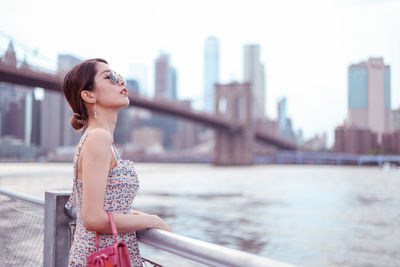 Young woman looking away in city