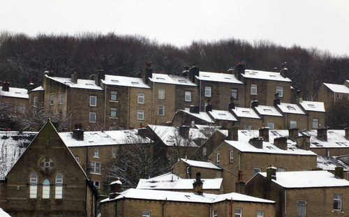 Houses against sky during winter