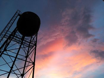 Low angle view of water tower against sky during sunset