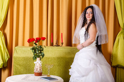 Young woman sitting on table