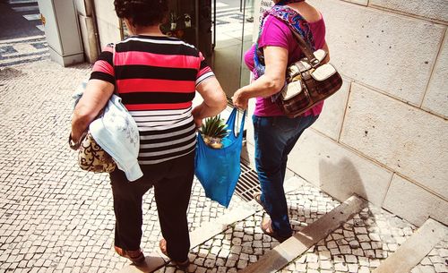 Woman standing on sidewalk