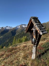 Traditional windmill on field against clear sky