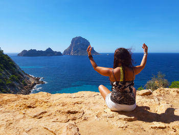 Tourist girl on vacation in the mediterranean sea in ibiza in front of es vedra in cala d'hort