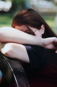Young woman covering face with hands