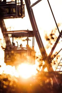 Low angle view of machine part against sky