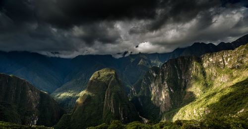 Panoramic view of mountains against storm clouds