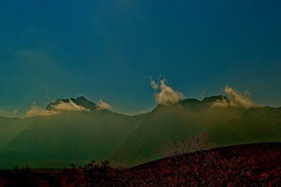 Scenic view of mountains against sky at night