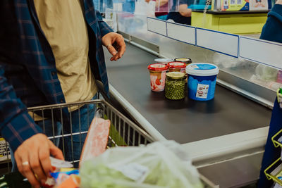 Midsection of man having food in store