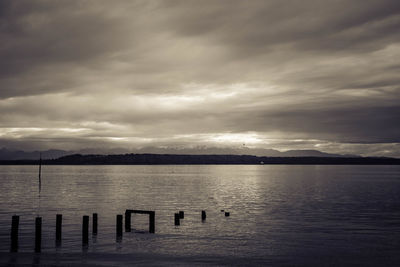 Scenic view of lake against cloudy sky