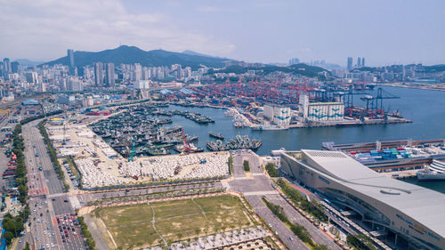 High angle view of cityscape by sea against sky