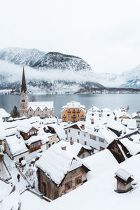 Built structure on snow covered mountain against sky
