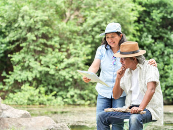 Mature couple holding map field