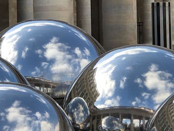 Reflection of buildings on cloudy sky