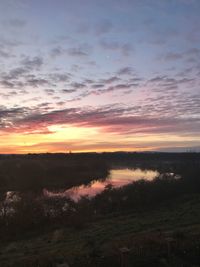 Scenic view of landscape against sky at sunset