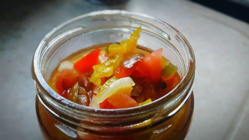 High angle view of salsa criolla in bottle on table