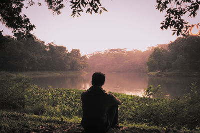 Rear view of a silhouette man in water