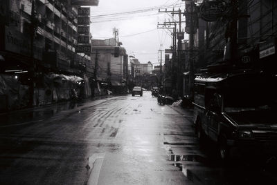 Street amidst buildings in city against sky