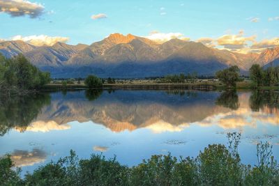 Scenic view of lake and mountains against sky