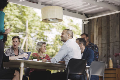 Happy business people discussing at desk in portable office truck