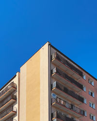 Low angle view of building against clear blue sky